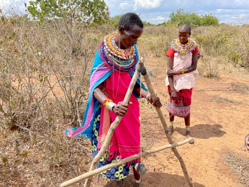Man uses an A-frame to map the contour of the site. 