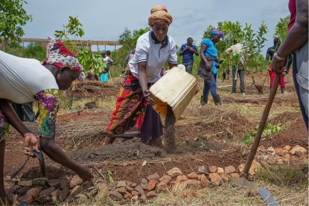 Woman amending soil.